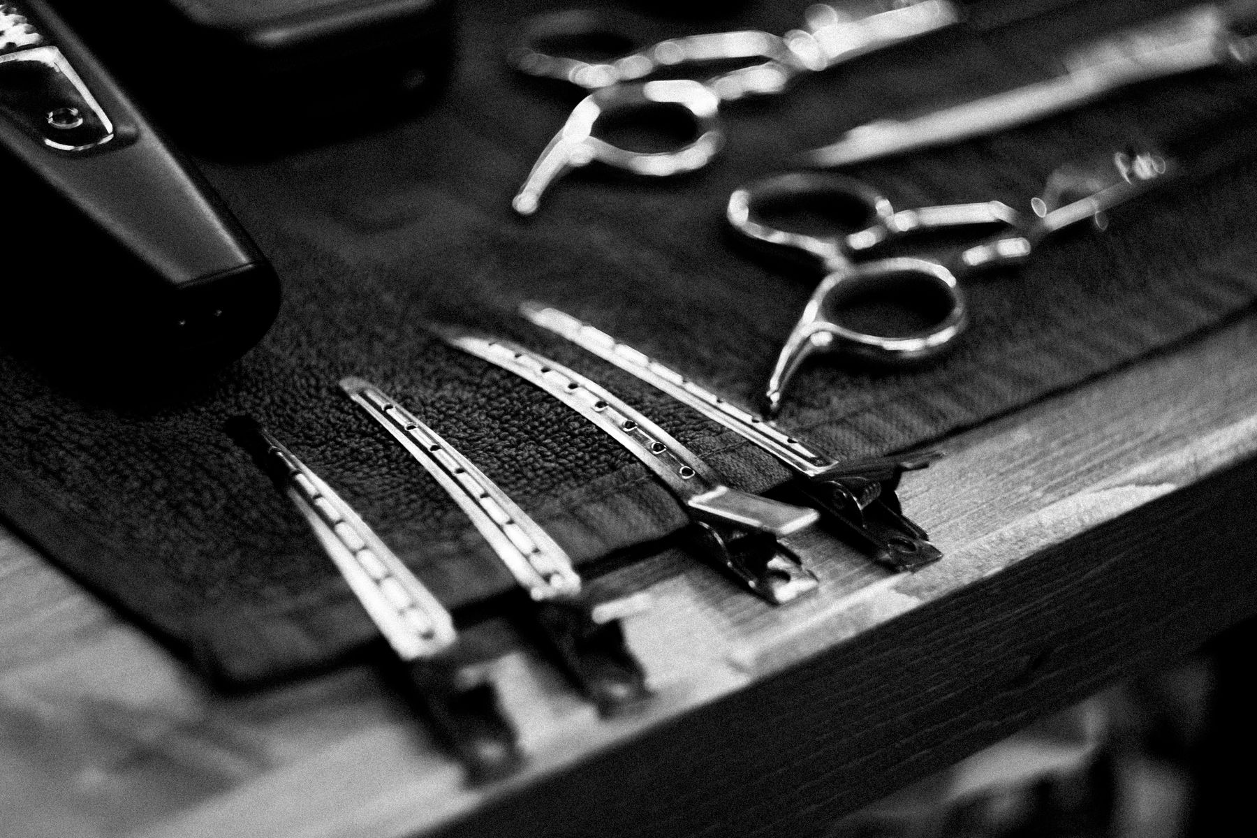 Salon scissors, combs and clips arranged on a towel, illustrative stock